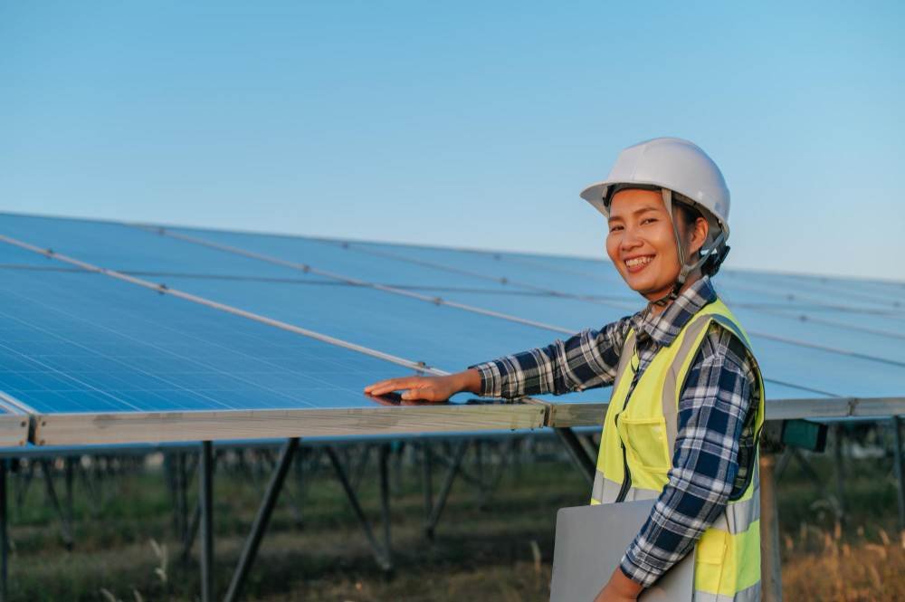 A female technician with solar panels